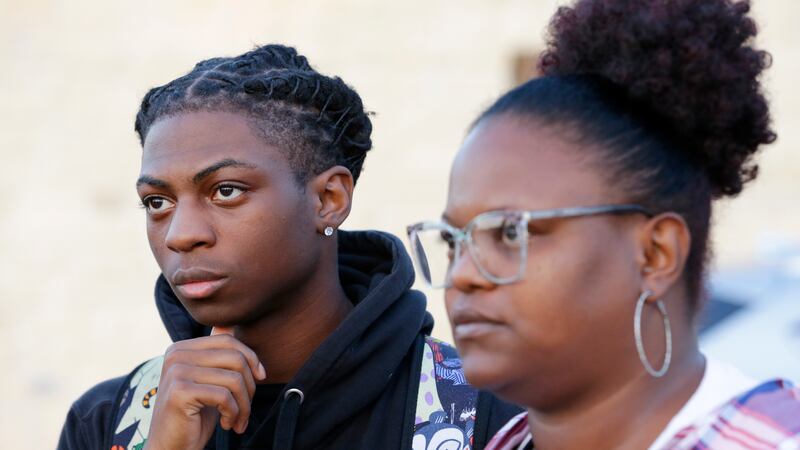 Darryl George, left, a 17-year-old junior, and his mother Darresha George, right, talks with...