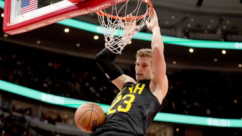 Utah Jazz's Lauri Markkanen dunks the ball during the second half of an NBA basketball game...