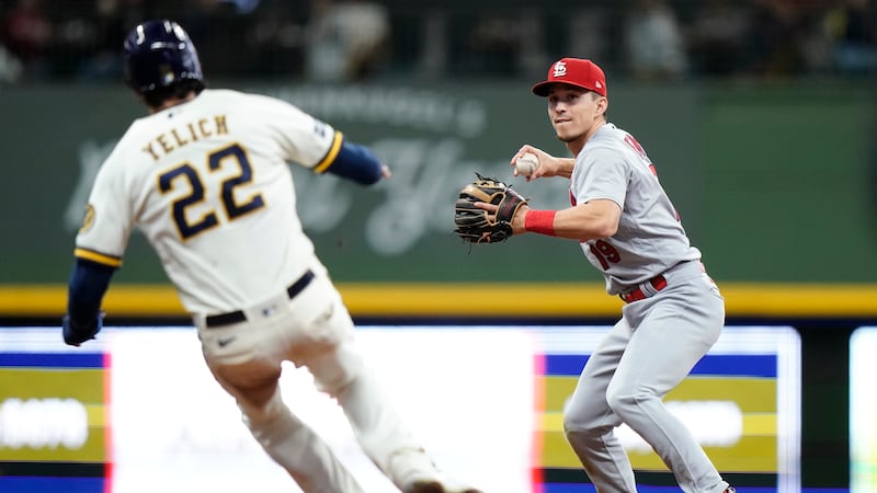 St. Louis Cardinals' Tommy Edman, right, tags Milwaukee Brewers' Christian Yelich (22) out at...