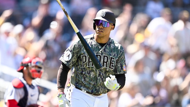 San Diego Padres' Juan Soto tosses his bat after hitting a three-run home run during the first...