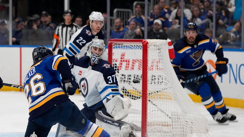 St. Louis Blues' Nathan Walker (26) scores past Winnipeg Jets goaltender Connor Hellebuyck...