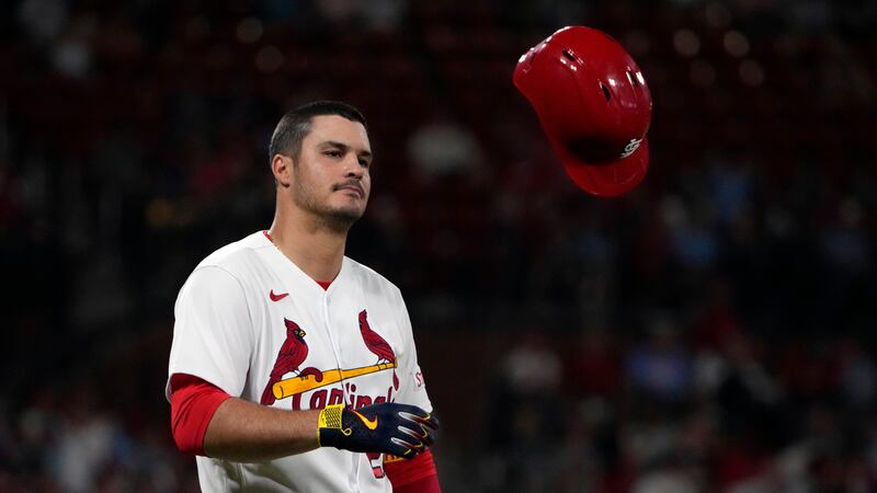 St. Louis Cardinals' Nolan Arenado tosses his helmet after flying out to end the eighth inning...