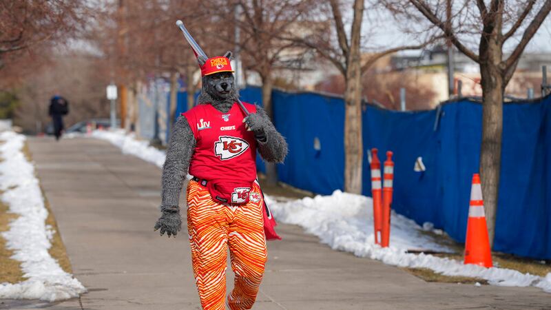 A Kansas City Chiefs fan, Chiefsaholic, walks toward Empower Field at Mile High before an NFL...