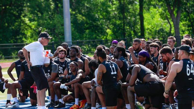 Showcase executive Stephen Austin (left) giving players instructions to players at the XFL...