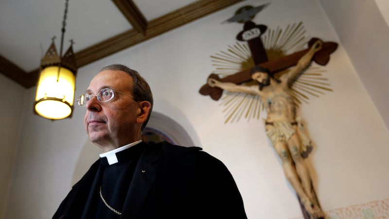 FILE - Baltimore Archbishop William Lori speaks with reporters before an Ash Wednesday Mass in...