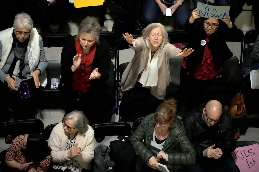 People applaud during a rally in favor of legislation banning gender-affirming healthcare for...
