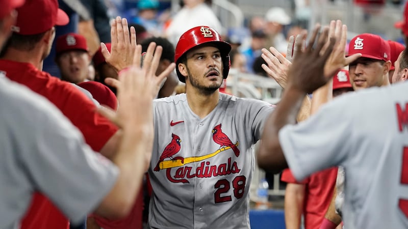 St. Louis Cardinals third baseman Nolan Arenado (28) is congratulated by his teammates after...