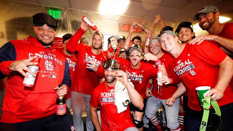 Members of the St. Louis Cardinals celebrate after defeating the Milwaukee Brewers in a...