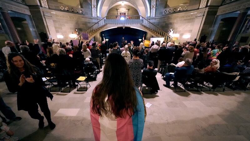 Glenda Starke wears a transgender flag as a counterprotest during a rally in favor of a ban on...