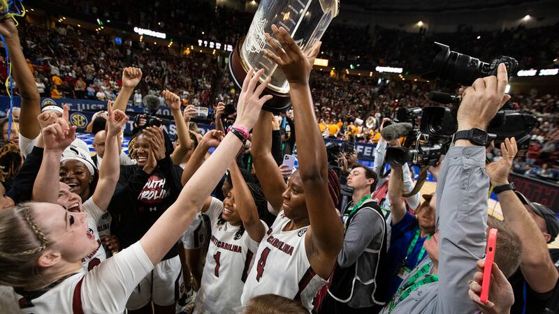 South Carolina's Aliyah Boston holds up the championship trophy after defeating Tennessee...