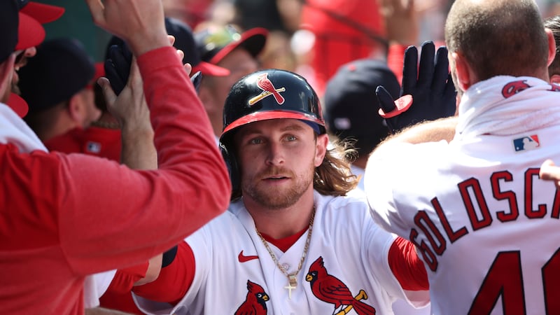 St. Louis Cardinals' Brendan Donovan celebrates with teammates in the dugout after hitting a...