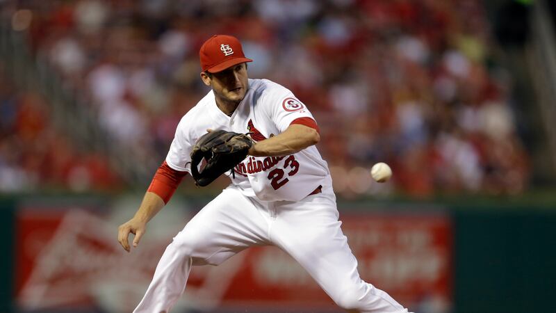 St. Louis Cardinals third baseman David Freese misplays a grounder hit by Pittsburgh Pirates'...
