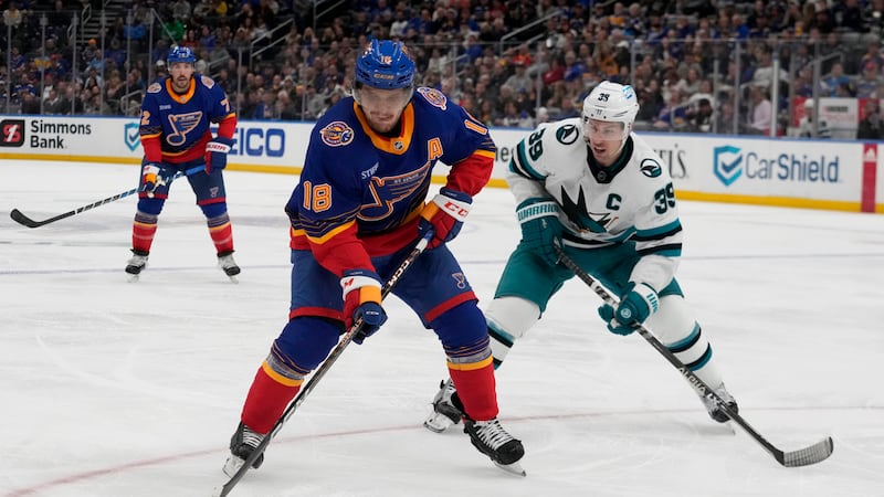 St. Louis Blues' Robert Thomas (18) handles the puck as San Jose Sharks' Logan Couture (39)...