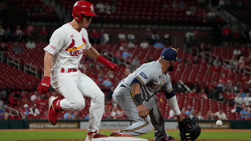 St. Louis Cardinals' Tommy Edman, left, is safe at first for a single as Milwaukee Brewers...