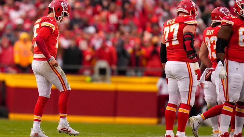 Kansas City Chiefs quarterback Patrick Mahomes (15) limps back to the huddle against the...