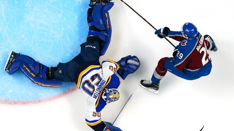 St. Louis Blues goaltender Jordan Binnington (50) blocks a shot by Colorado Avalanche center...