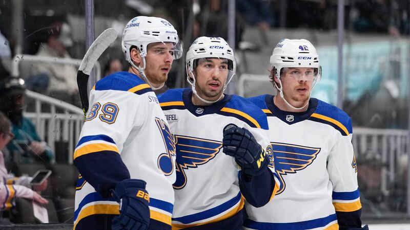 St. Louis Blues center Jordan Kyrou, middle, celebrates with left wing Pavel Buchnevich, left,...