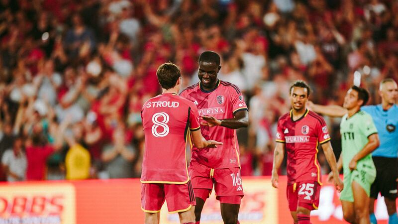 Forward Samuel Adeniran and midfielder Jared Stroud embrace after a goal against Austin FC.