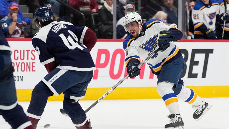 St. Louis Blues left wing David Perron, right, shoots a goal past Colorado Avalanche...
