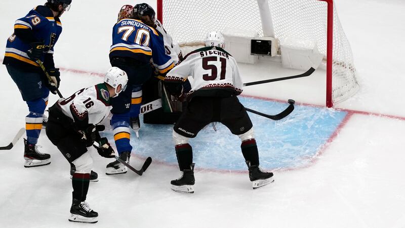 St. Louis Blues' Oskar Sundqvist (70) scores as Arizona Coyotes' Troy Stecher (51) watches...