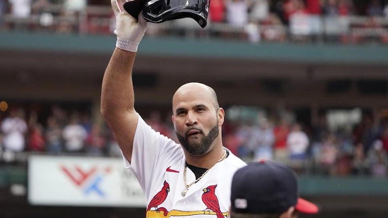 St. Louis Cardinals' Albert Pujols tips his cap after hitting a two-run home run during the...