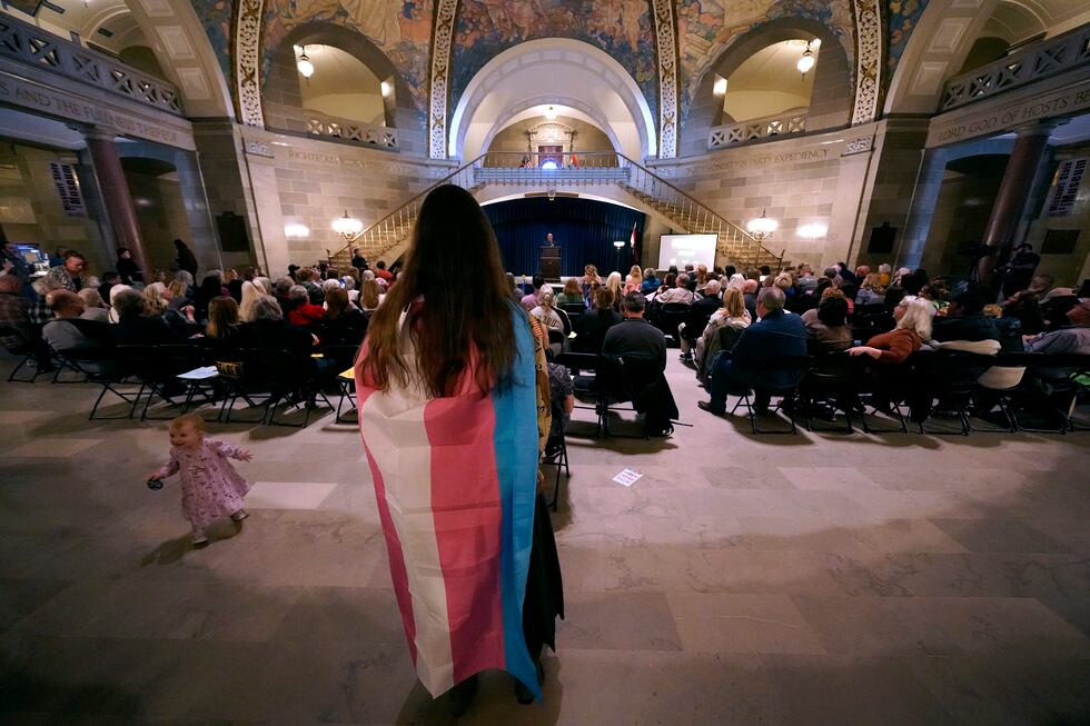 Glenda Starke wears a transgender flag as a counterprotest during a rally in favor of a ban on...