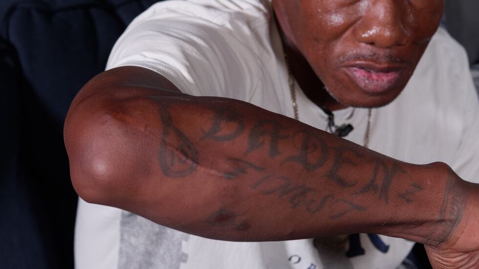 Malcolm Johnson shows one of several tattoos he has.