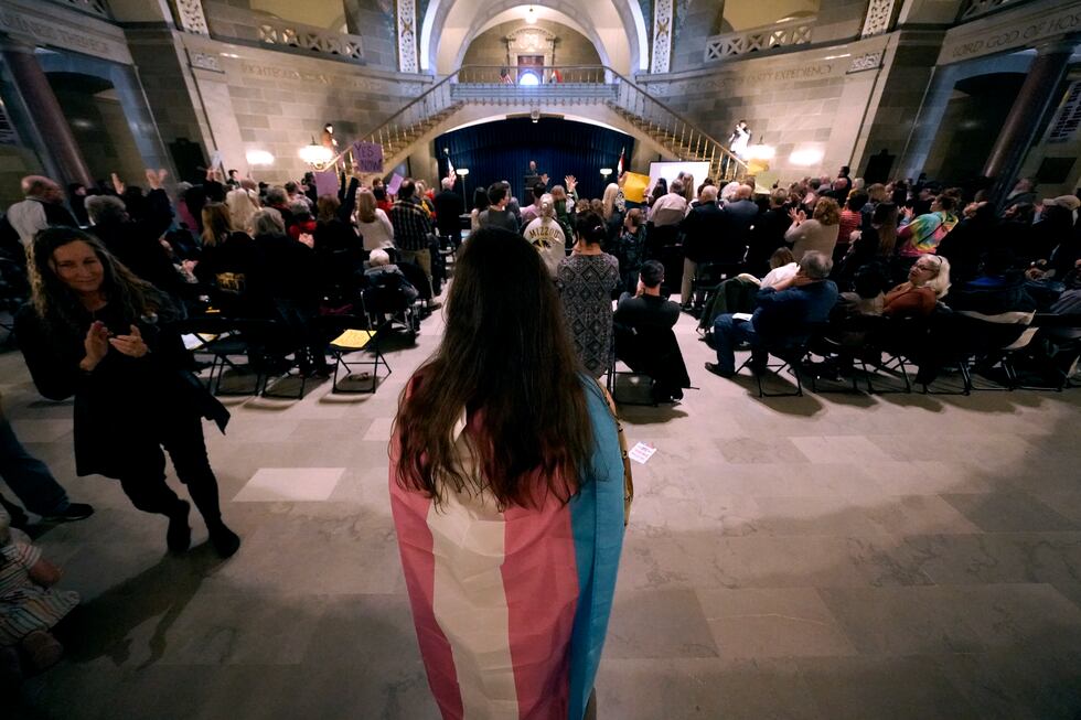 Glenda Starke wears a transgender flag as a counterprotest during a rally in favor of a ban on...