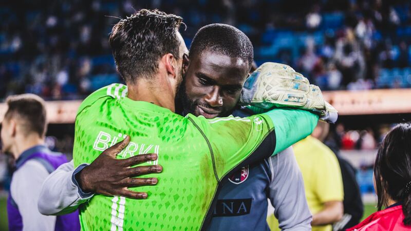 Goalkeeper Roman Bürki and forward Samuel Adeniran embrace after defeating San Jose...