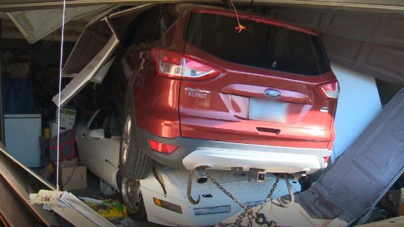 An SUV crashed through a Jefferson County garage and landed on top of a Corvette on March 20,...
