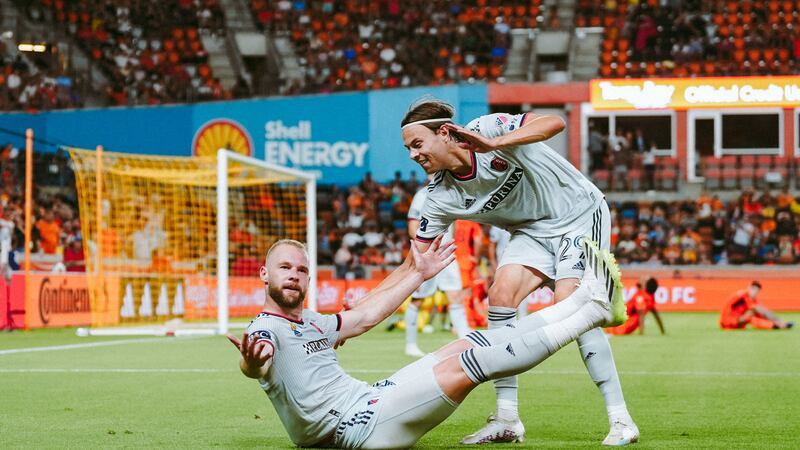 João Klauss and Nökkvi Thórisson celebrate after Klauss scored a goal against Houston Dynamo FC.