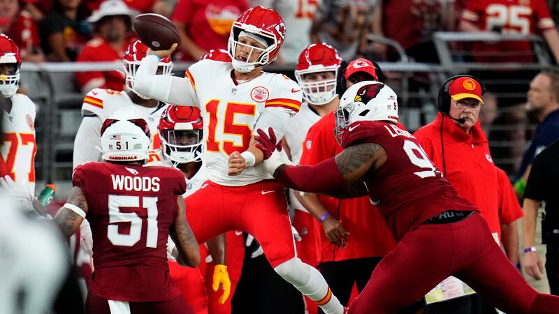 Kansas City Chiefs quarterback Patrick Mahomes (15) throws as he is pushed out of bounds by...