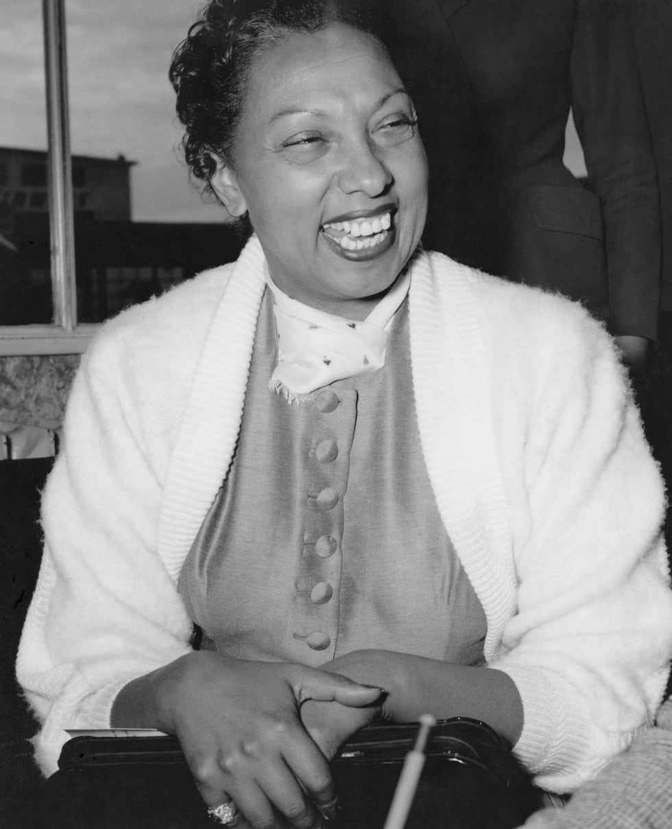 Josephine Baker jokes with newsmen who met her during a stop-over at Frankfurt's Rhein Main...