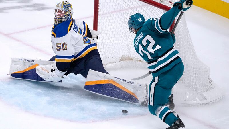 St. Louis Blues goaltender Jordan Binnington (50) blocks a shot by San Jose Sharks center...