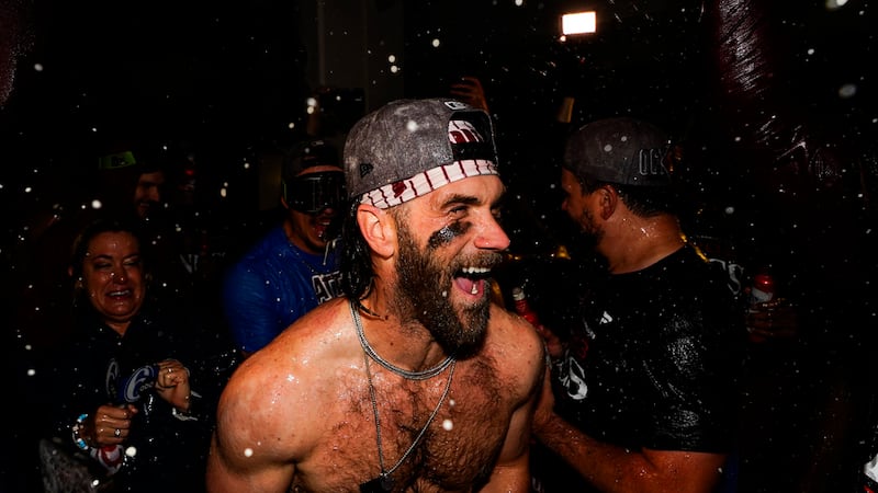 The Philadelphia Phillies celebrate after Game 4 of a baseball NL Division Series against the...