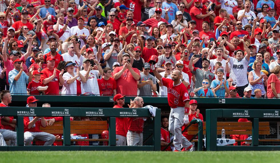 Los Angeles Angels' Albert Pujols waves to fans after getting a curtain call when he hit a...