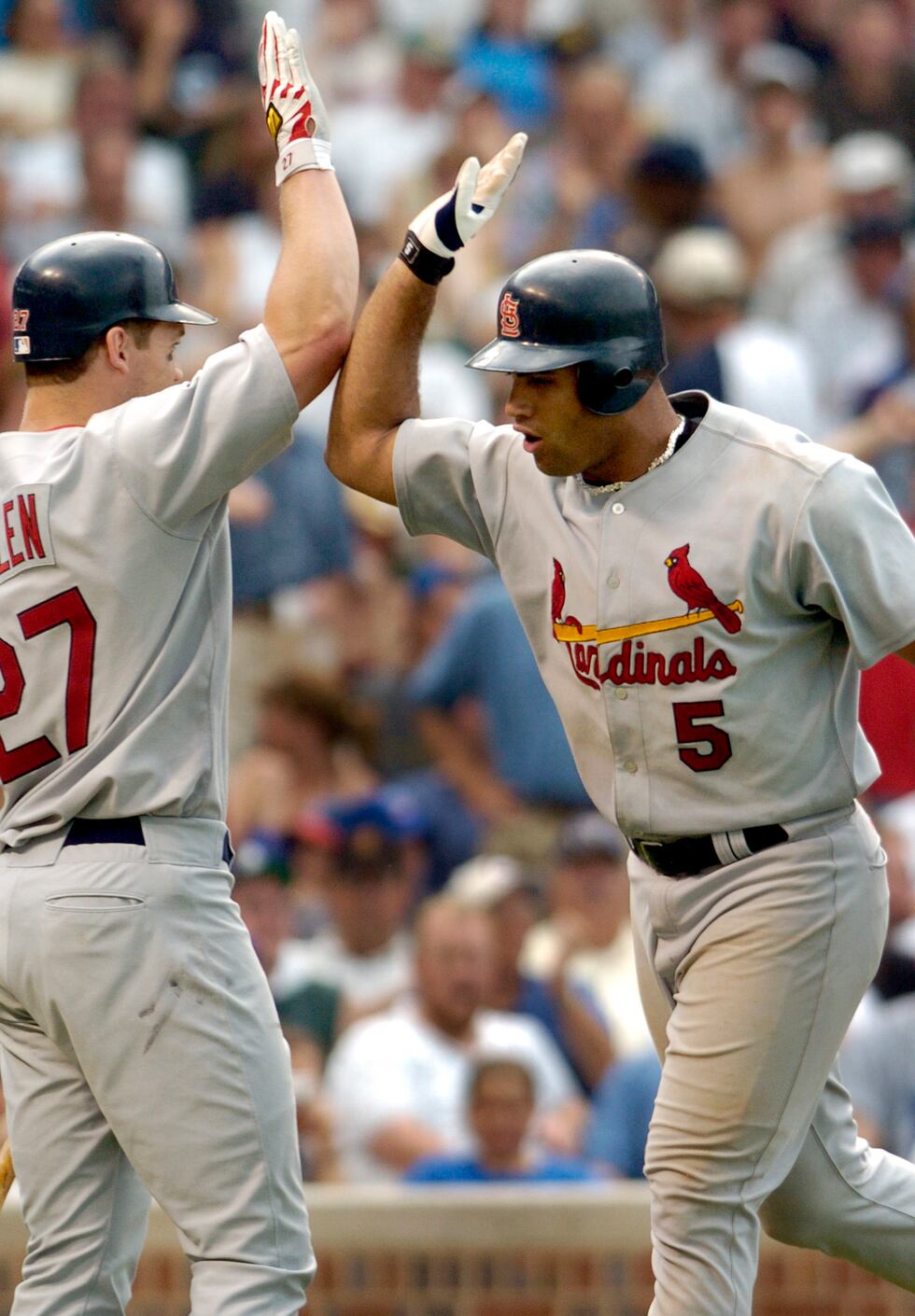 St. Louis Cardinals' Albert Pujols (5) is congratulated by teammate Scott Rolen, left, after...