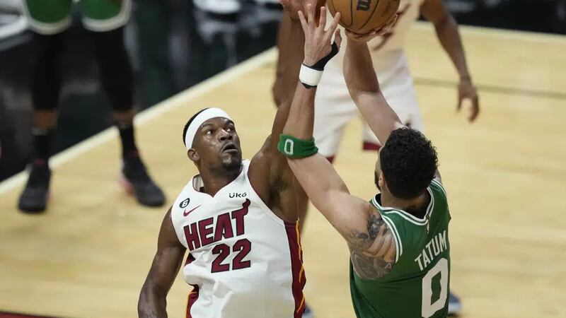 Miami Heat forward Jimmy Butler (22) attempts to block a shot to the basket by Boston Celtics...